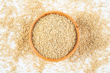 A wooden bowl of miscellaneous grains buckwheat on a white background
