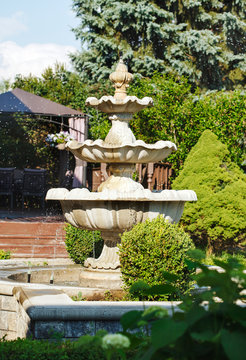 Splashing fountain in the summer garden