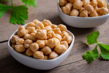 Cooked chick peas in white bowl.