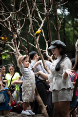 Asian mothers and children while traveling in the zoo together happily.