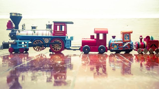 Christmas Toy Trains on a wooden floor with reflection 