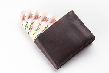 200 Egyptian pound bills in a dark brown wallet isolated on a white background 
