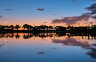 Obraz premium summer sunset on the lake with clouds reflection