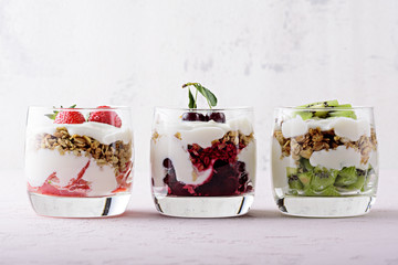 healthy dessert with whipped cottage cheese, granola, strawberries, cherries and kiwi on pink...