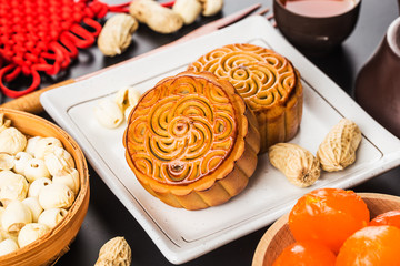 Traditional mooncakes on table setting with teacup.
