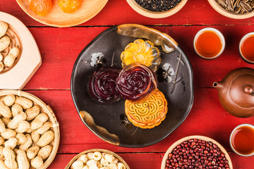 Traditional mooncakes on table setting with teacup.