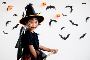 Cute asian child girl wearing halloween costumes and makeup having fun on Halloween celebration