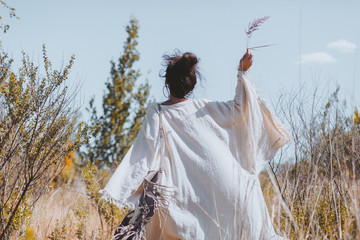 beautiful young woman walking on a field