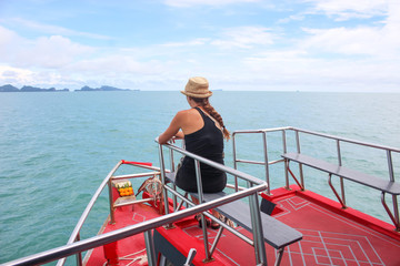 Tourists girl are enjoying on the tour boat in the sea