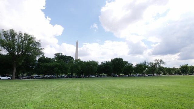 Wide of the Washington Monument through some trees located in Washington DC in the USA