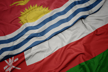 waving colorful flag of oman and national flag of Kiribati .
