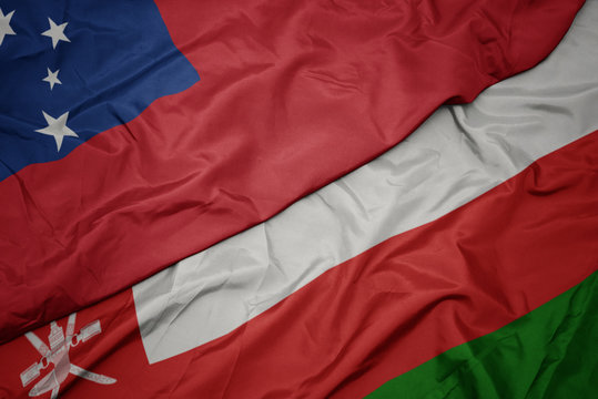 waving colorful flag of oman and national flag of Samoa .