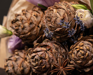 bouquet of cedar cones, purple and white roses