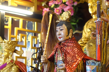 Colorful Taoist goddess sculpture in Taoism temple. Selective focus.