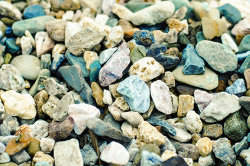 The gravels background, there are a lot of gravels that different shape and colors on the floor. 