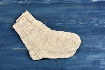 Wool socks on blue wooden background
