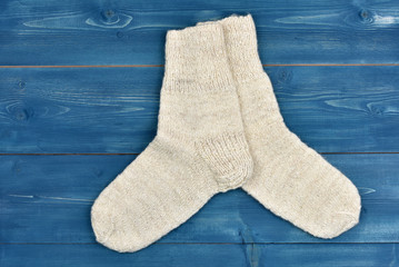 Wool socks on blue wooden background