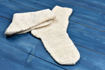 Wool socks on blue wooden background