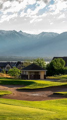 Vertical Golf course and residential area overlooking the lake mountain and valley