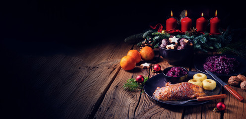 Roast goose with baked apples, red cabbage and dumplings