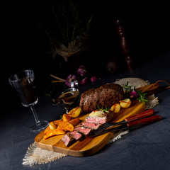 rustic medium butter beef steak with herbs and potato wedges