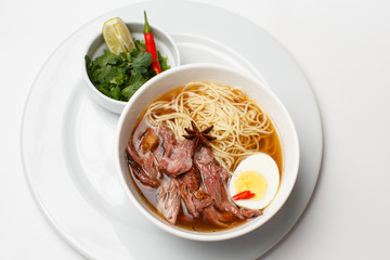 a beef and noodle soup with eggs