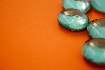 Close up of glass pebbles on a plain background