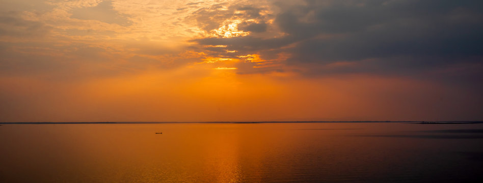 Fishermen are fishing in the lake. on holidays when the sun sets. golden sun light with reflections on the lake. concept