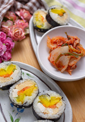 Kimchi and Gimbap serving on white plate