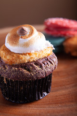 Cupcake and Macaroons close up on wood platter