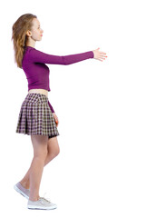 Fototapeta premium Back view of a woman who comes welcomes someone with hand.