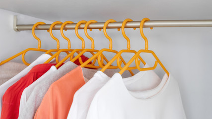 Different clothes on the rank in store. Concept for choice of fashion clothes. Fashion large...
