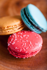 Macaroons close up on wood platter