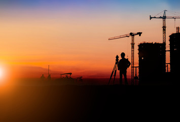 Fototapeta na wymiar Silhouette of Survey Engineer and construction team working at site over blurred industry background with Light fair.Create from multiple reference images together