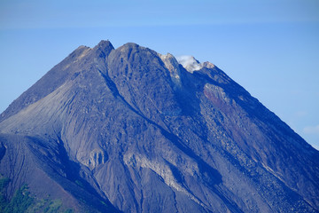 Fototapeta na wymiar Summit of Merapi Volcano in Yogyakarta, a view from Merbabu Mountain, Magelang, Central Java, Indonesia.