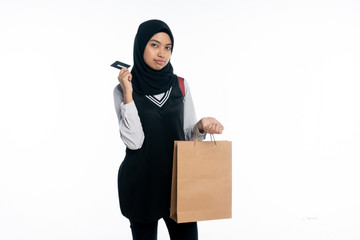 Asian woman is holding a paper bag and holding a card on a white background