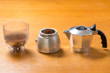 Moka pot and coffee beans and grinder.