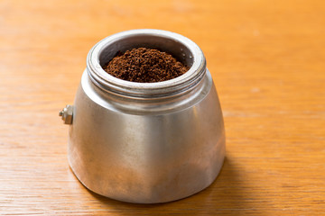 Moka pot and coffee beans and grinder.