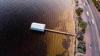 Aerial shot of boat shed by the river