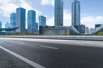 Fototapeta na wymiar empty urban road with modern building in the city.
