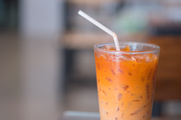 Thai milk tea in glass with straw
