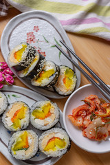 Kimchi and Gimbap serving on white plate
