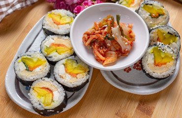 Kimchi and Gimbap serving on white plate