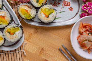 Kimchi and Gimbap serving on white plate