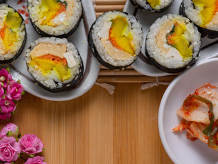 Kimchi and Gimbap serving on white plate
