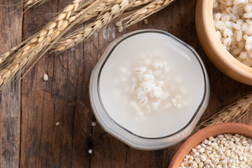 Barley water in glass with raw and cooked