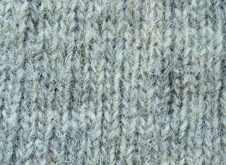  Background knitting from natural wool yarn of gray color.