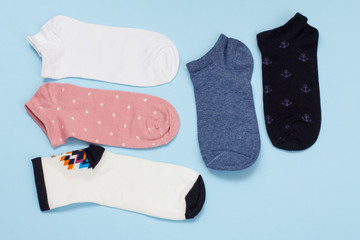 Five pair of women socks on blue background.