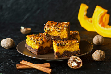 Food for Halloween. Homemade chocolate brownie with nuts and a layer of pumpkin. Cinnamon