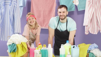 Optimistic young couple have pleased expression. Isolated blue background